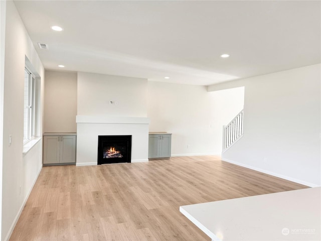 unfurnished living room featuring light hardwood / wood-style flooring