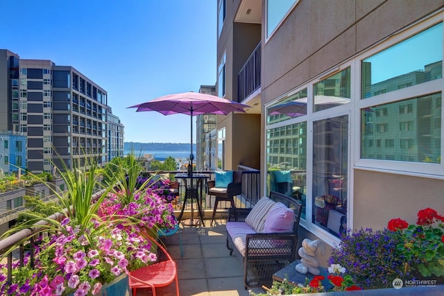 balcony featuring a water view and a patio