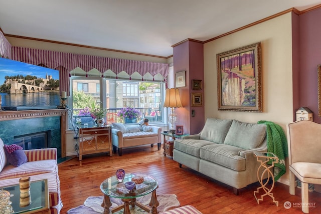 living room featuring ornamental molding, wood-type flooring, and a premium fireplace