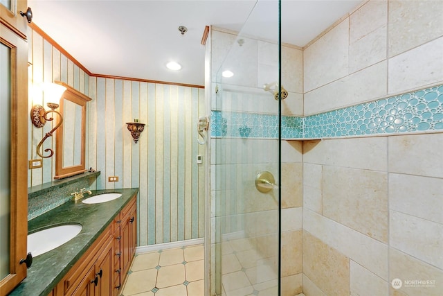 bathroom with vanity, crown molding, and tiled shower