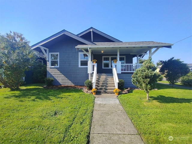 bungalow-style home featuring a porch, a front lawn, and stairway