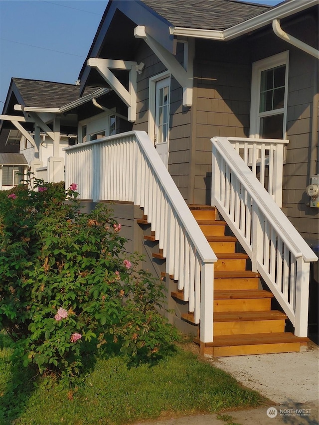 property entrance with roof with shingles