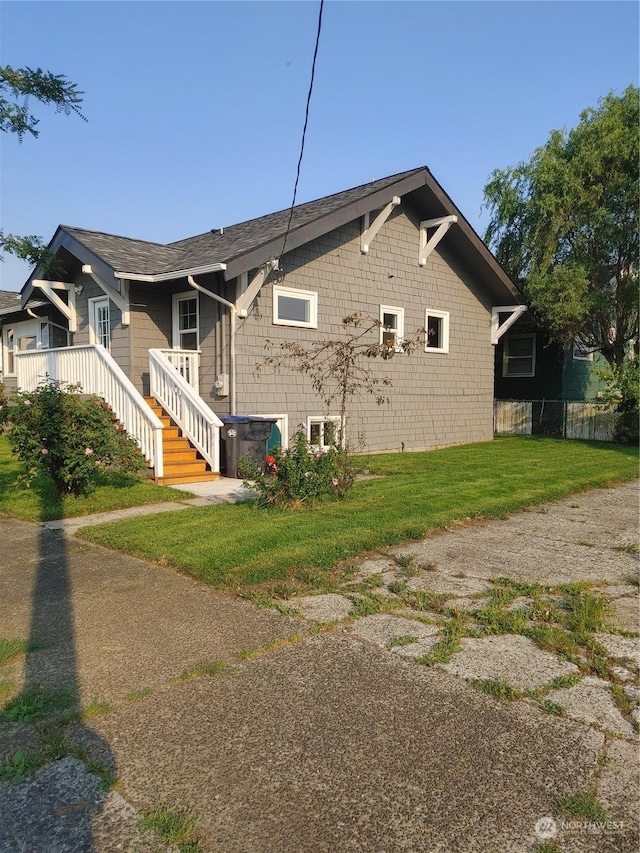 view of side of home with a yard