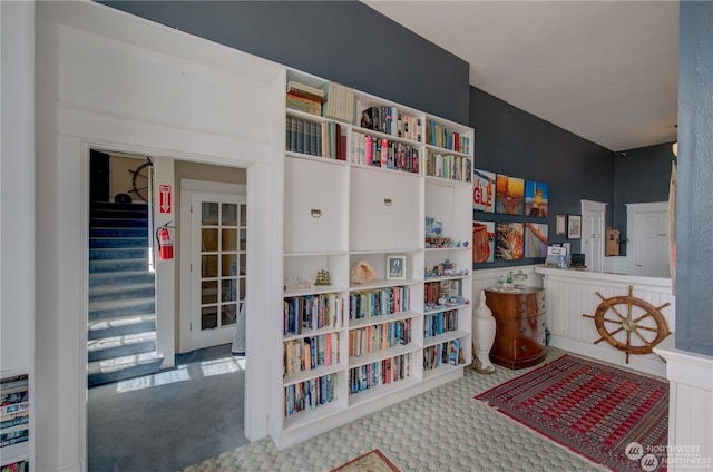 interior space featuring stairs and carpet