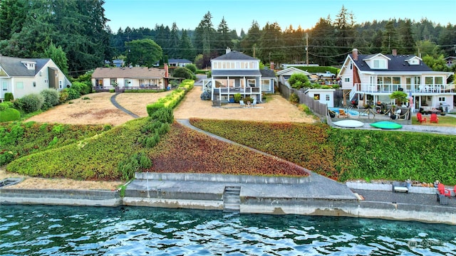 rear view of house featuring a patio area and a water view