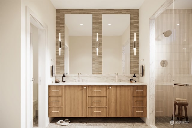 bathroom featuring a shower, double sink vanity, tile walls, and tile patterned flooring