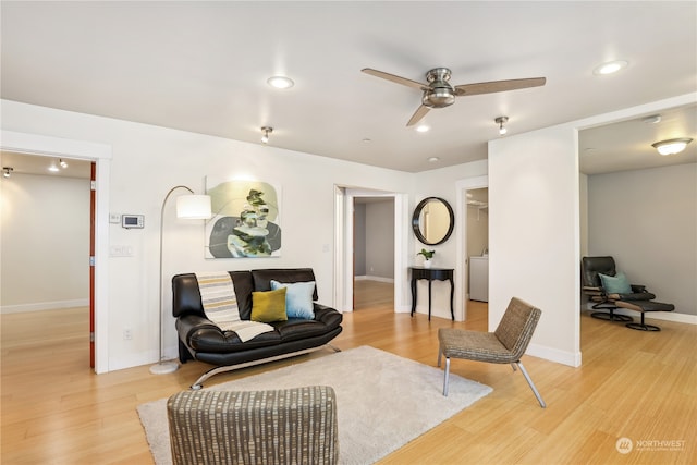 sitting room with ceiling fan and light hardwood / wood-style flooring