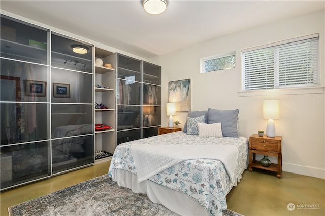 bedroom featuring concrete flooring