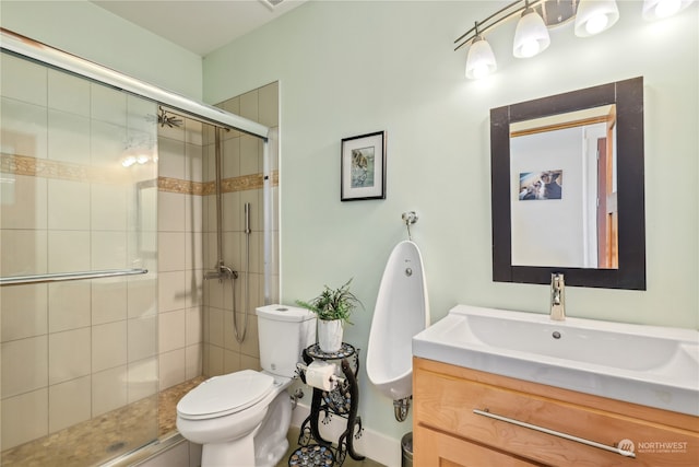 bathroom with a shower with door, vanity, and toilet