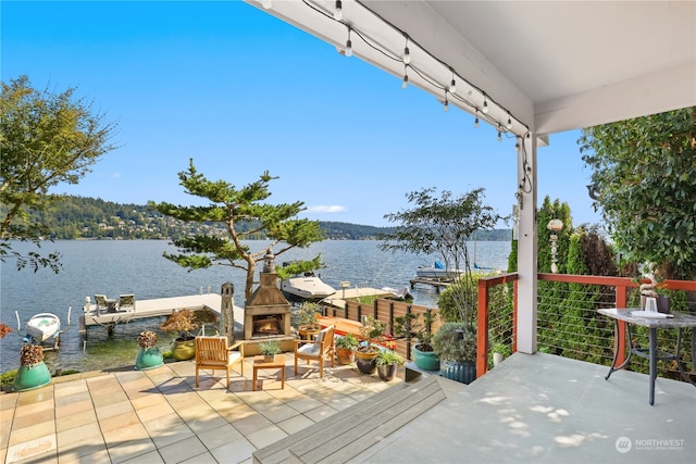 view of patio / terrace featuring a water view and a dock