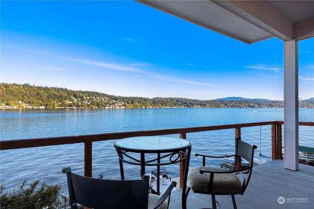 balcony with a water and mountain view