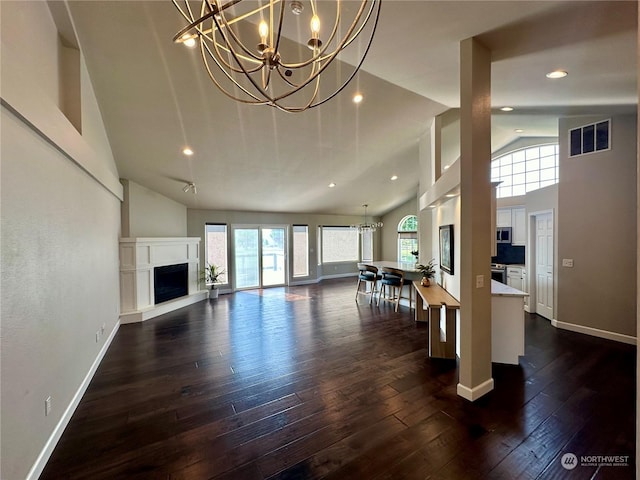 living room with a wealth of natural light and dark hardwood / wood-style flooring