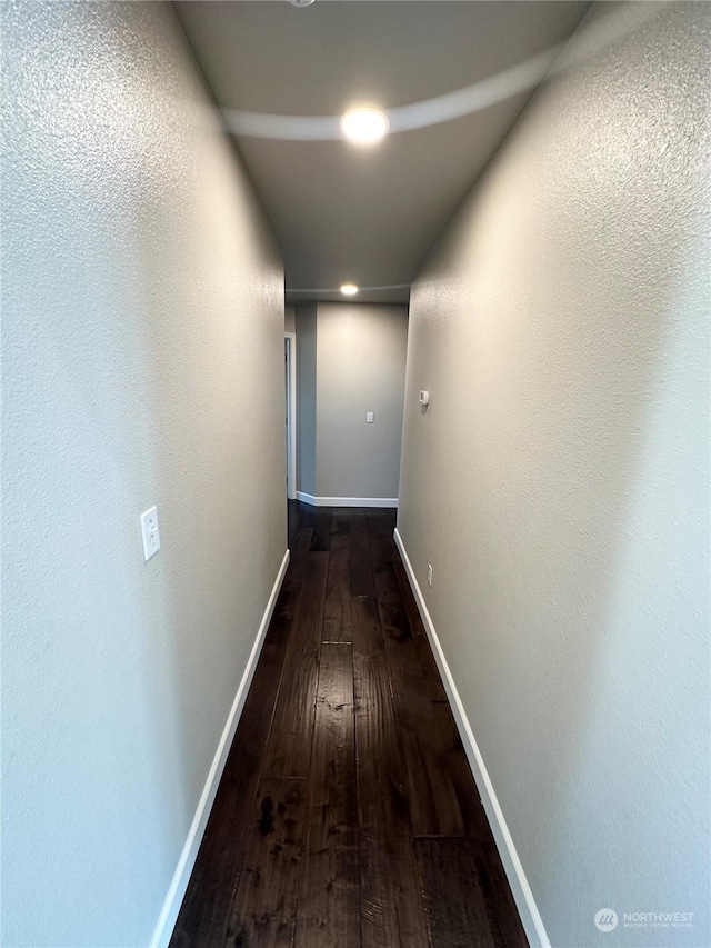 hallway with dark hardwood / wood-style floors