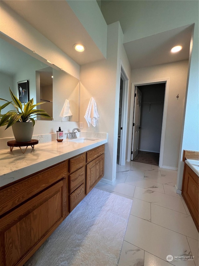 bathroom with vanity and a tub