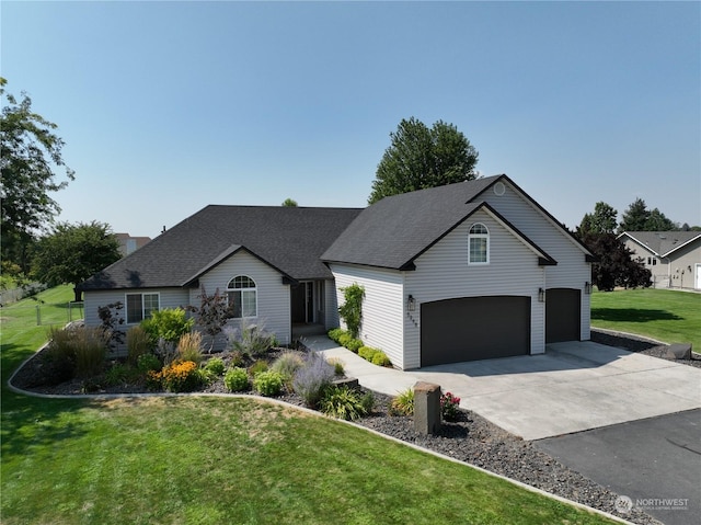 view of front of property with a garage and a front lawn