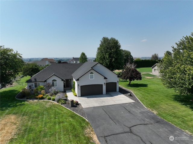 view of front of home with a garage and a front lawn