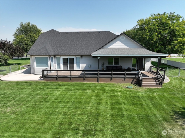 rear view of property with a lawn and a patio area