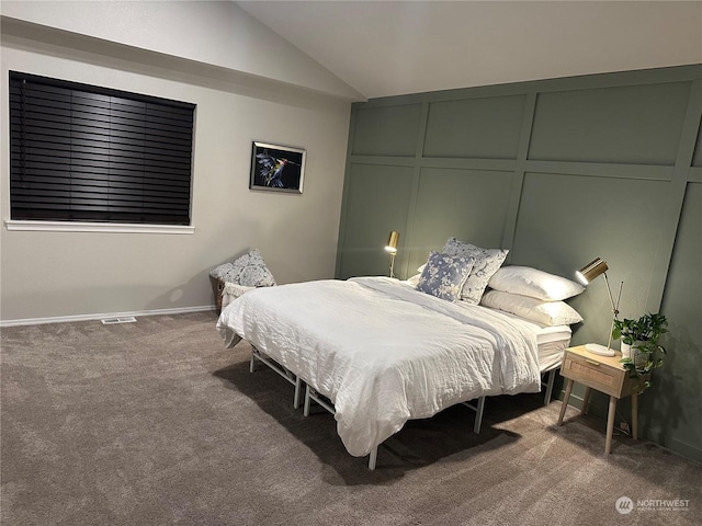 carpeted bedroom featuring lofted ceiling