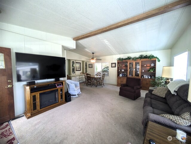 living room featuring ceiling fan, carpet floors, and lofted ceiling with beams