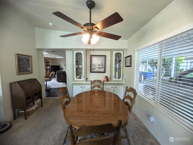 carpeted dining area featuring a textured ceiling and ceiling fan