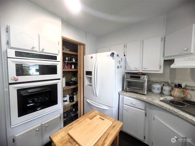 kitchen featuring white cabinetry and white appliances