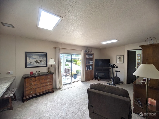 living room featuring a textured ceiling and light colored carpet