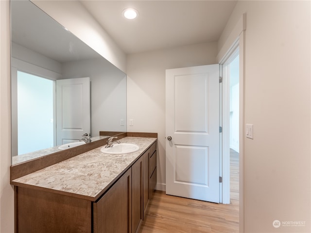 bathroom with vanity and hardwood / wood-style floors