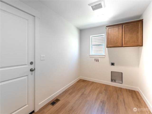 laundry area featuring cabinets, hookup for a washing machine, light wood-type flooring, and electric dryer hookup