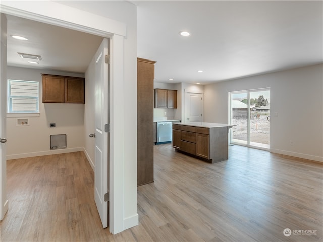 kitchen with dishwasher, a center island, and light hardwood / wood-style floors