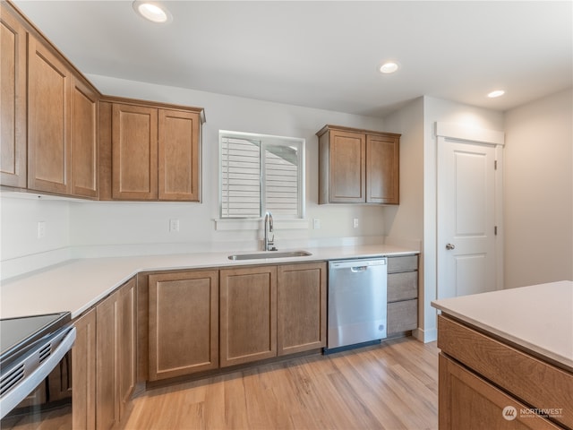 kitchen featuring sink, stainless steel appliances, and light hardwood / wood-style floors