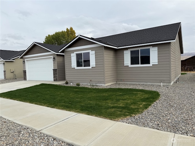 view of front of house featuring a front yard and a garage