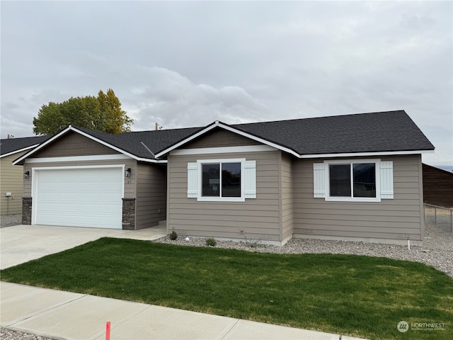 view of front of house with a front yard and a garage