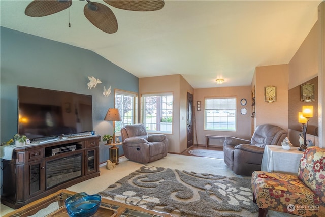 living room featuring carpet, baseboards, and vaulted ceiling