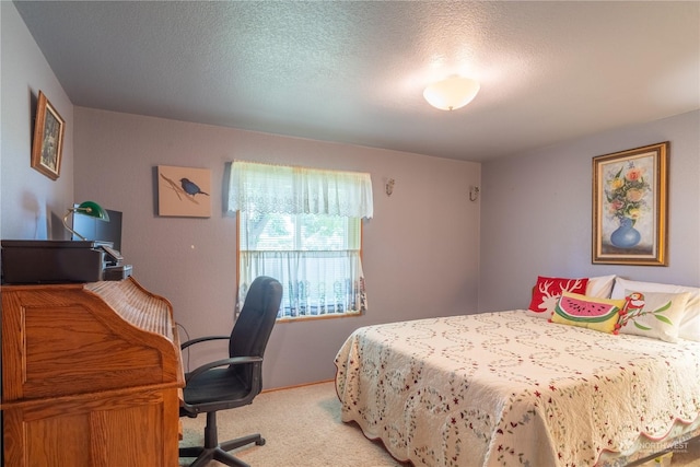 bedroom featuring light carpet and a textured ceiling