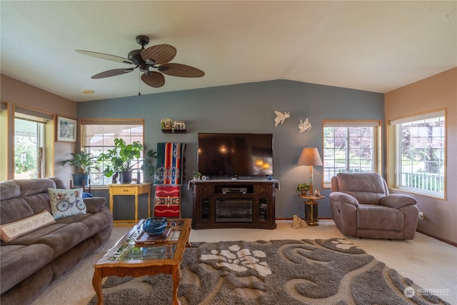 carpeted living area featuring lofted ceiling, baseboards, a wealth of natural light, and a ceiling fan