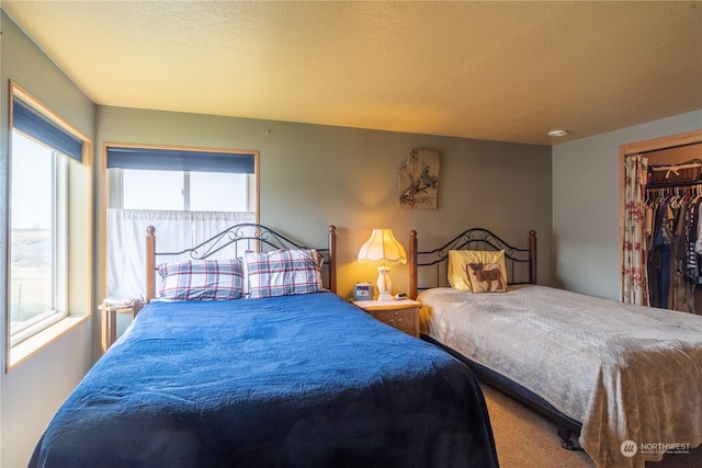 carpeted bedroom with a textured ceiling