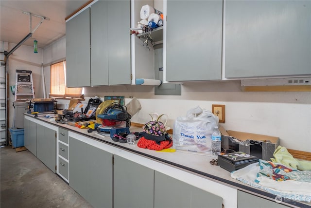 kitchen featuring concrete flooring, light countertops, and gray cabinetry