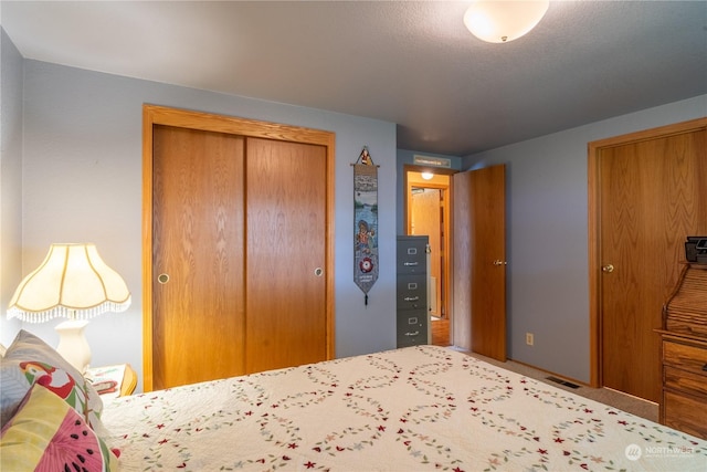 unfurnished bedroom with a closet and visible vents