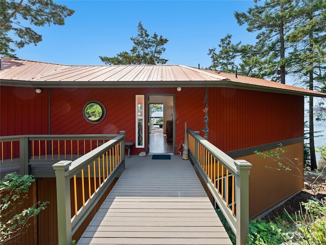 exterior space with a deck and metal roof