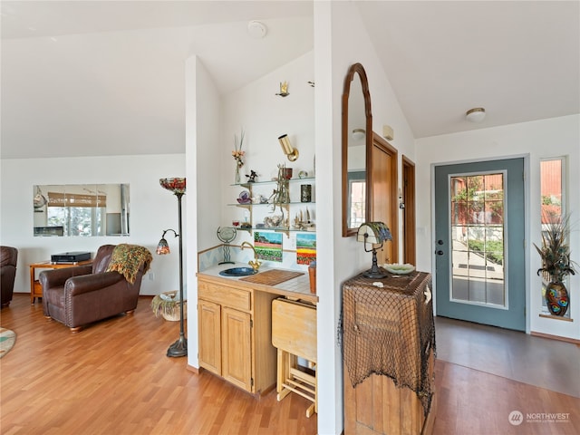 entrance foyer featuring high vaulted ceiling and light wood-type flooring