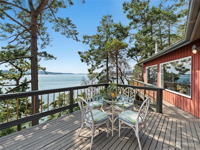 wooden terrace featuring a water view