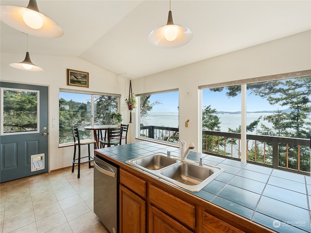 kitchen with tile counters, a water view, dishwasher, light tile patterned flooring, and sink