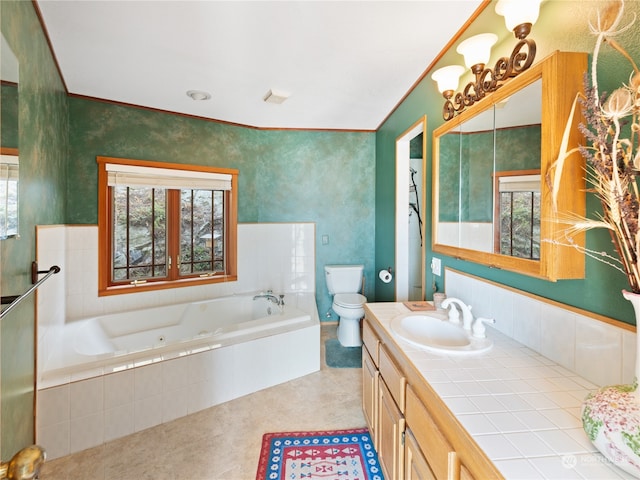 bathroom featuring crown molding, toilet, tiled tub, tile patterned flooring, and vanity