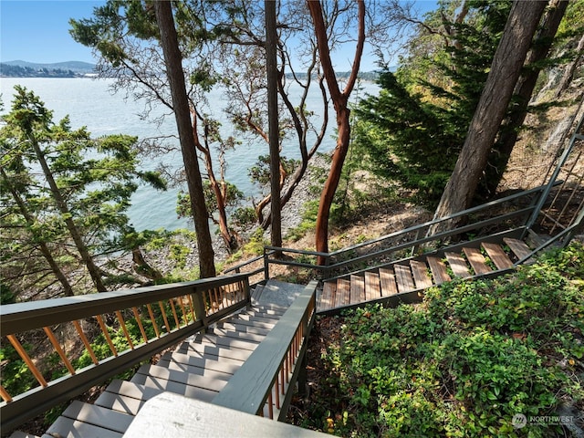 wooden deck with a water and mountain view