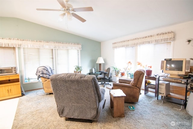 carpeted living room featuring ceiling fan and lofted ceiling