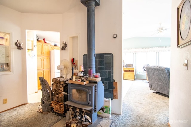 interior space with carpet floors and a wood stove