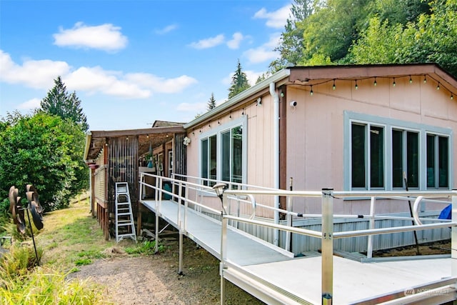 view of side of home with a wooden deck