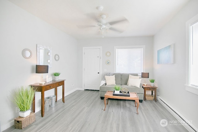 living room featuring ceiling fan and light hardwood / wood-style flooring