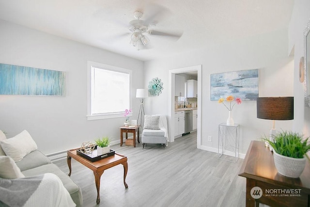 317 2nd Ave NW, Kelso, WA 98626 - living room featuring ceiling fan, baseboards, and light wood-style flooring