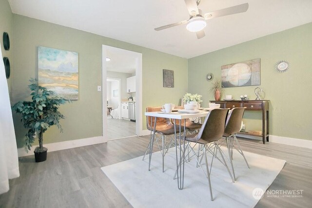 dining space with ceiling fan and light hardwood / wood-style floors